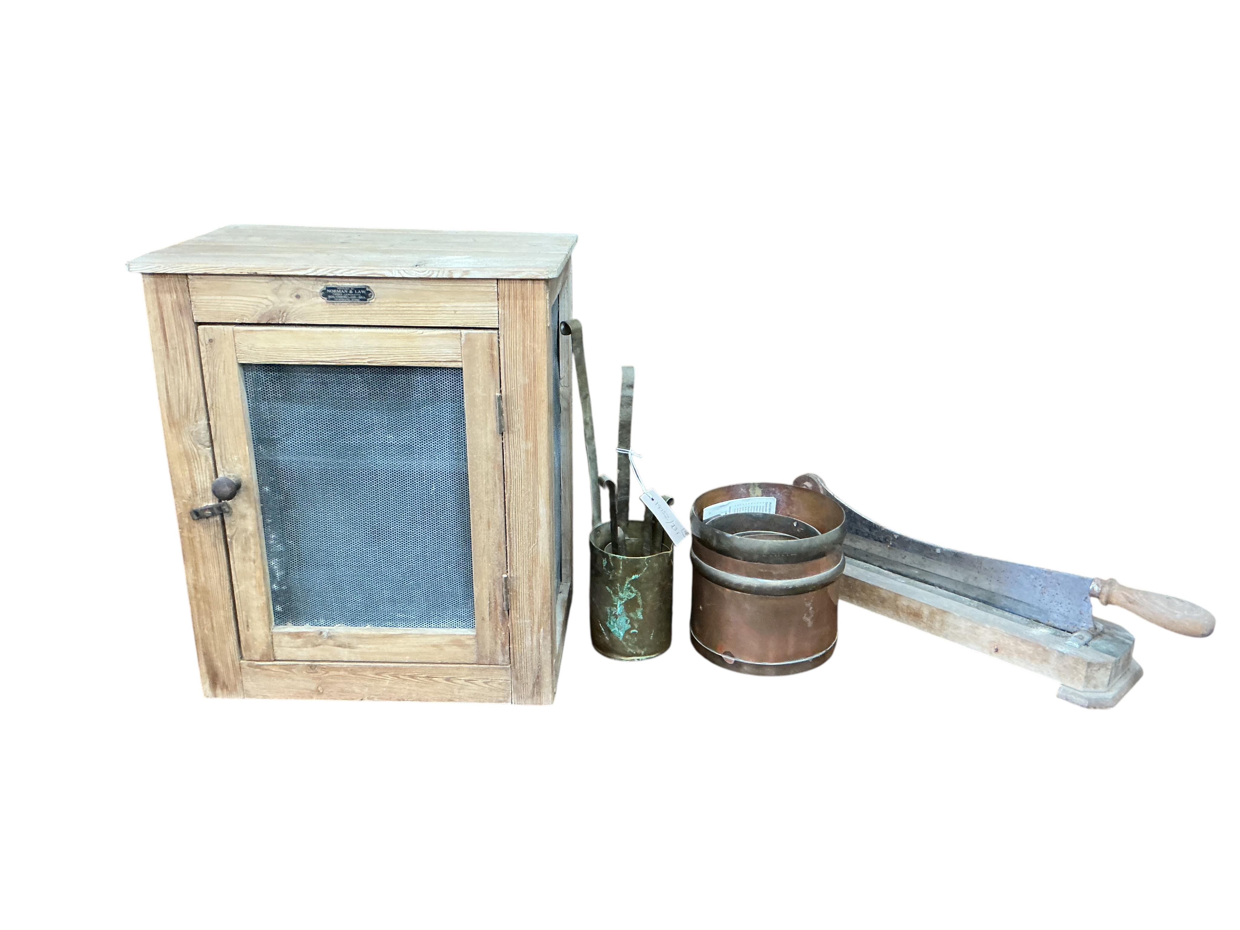 A set of eight Victorian brass and copper graduated bushel measures, one other set of measures, a chopper and a small pine meat safe